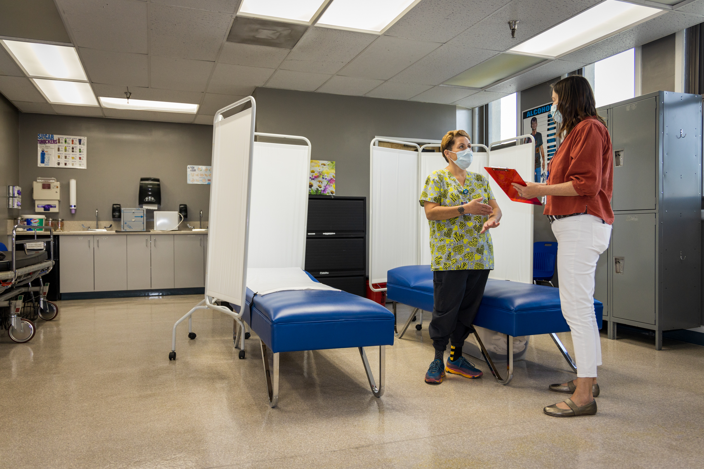 Nurse Practitioner Colleen McEvoy (r) runs through an upcoming appointment with Medical Assistant Brandy Park. Photo by Barbara Laughon/NIHD